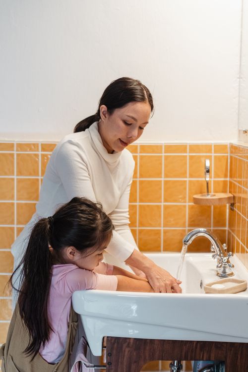 Parent and child washing hands together